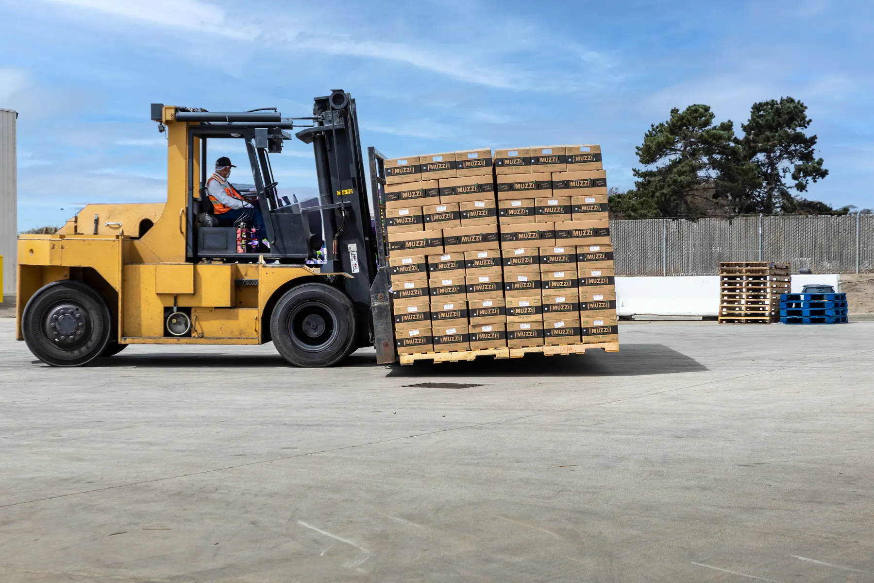 Forklift moving a pallet of boxed produce